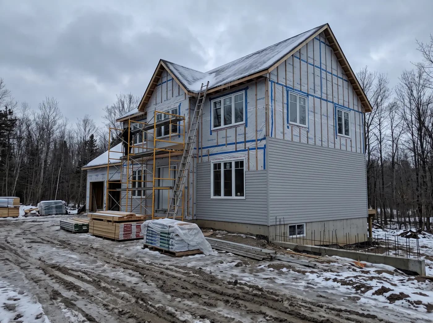 Wrap taped and the first course of siding on a two-storey house